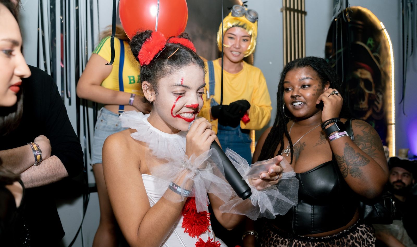 A guest singing into a microphone during the Halloween Crawl